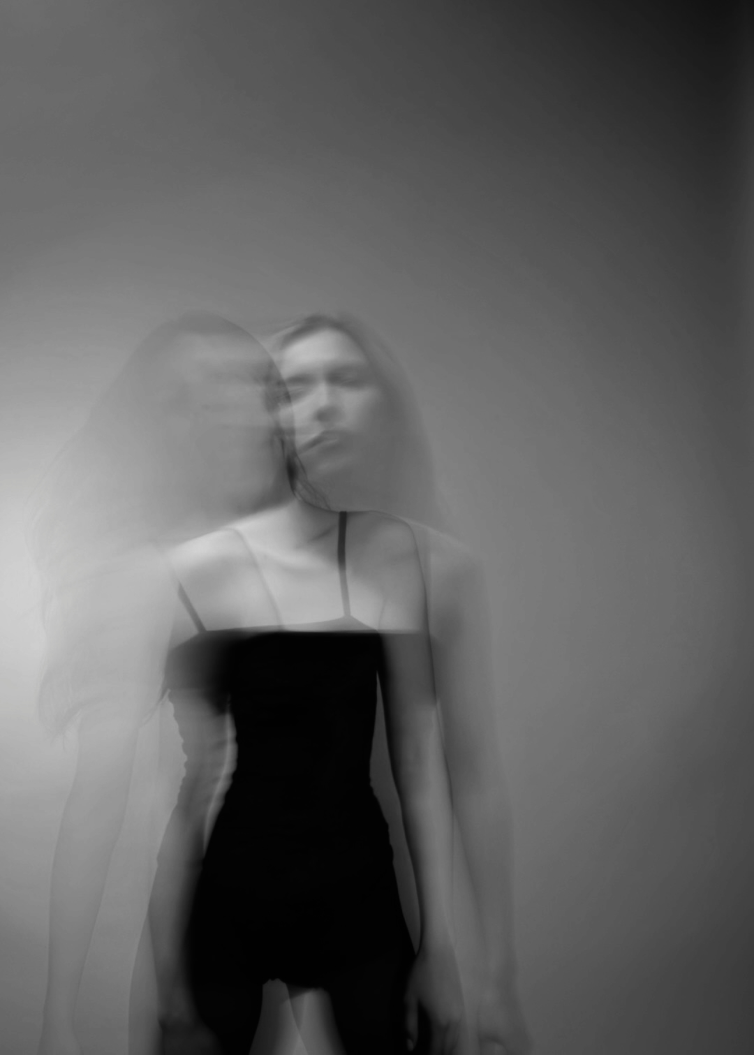 Black-and-white portrait of Daria Voit with a blurred double exposure.